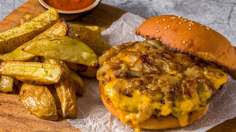 Smash burger with melted cheese, sauce, and onions