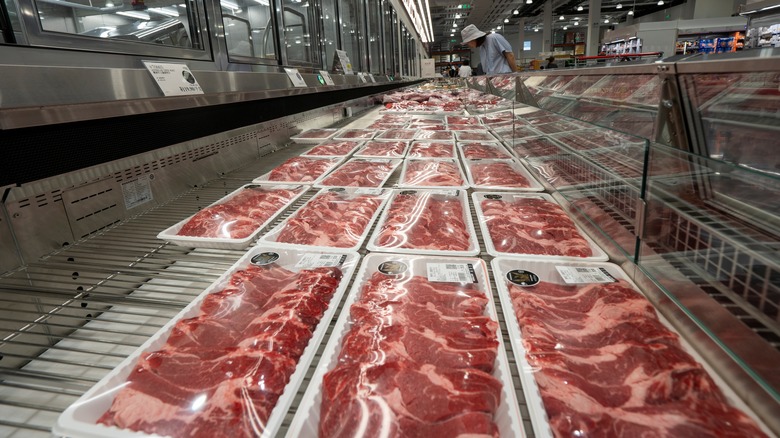 Costco shopper looking at meat selection