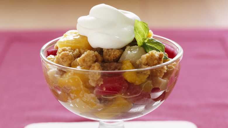 watermelon and peach cobbler in a glass bowl with whipped cream