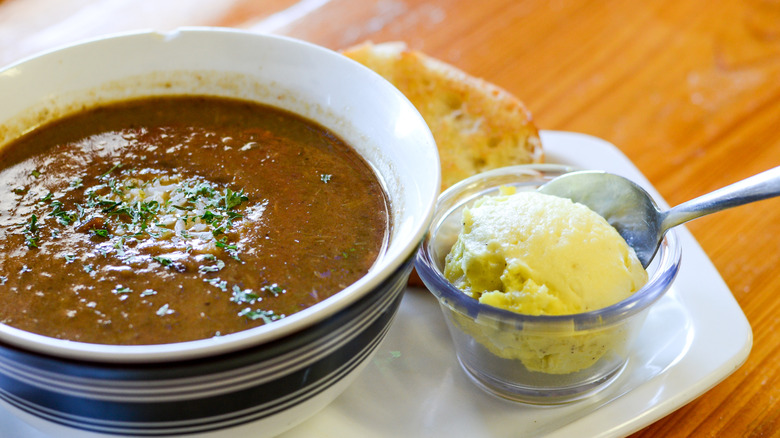 Bowl of gumbo with potato salad on the side