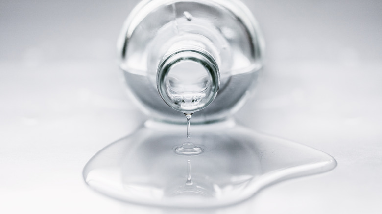 A bottle on its side with water spilling out