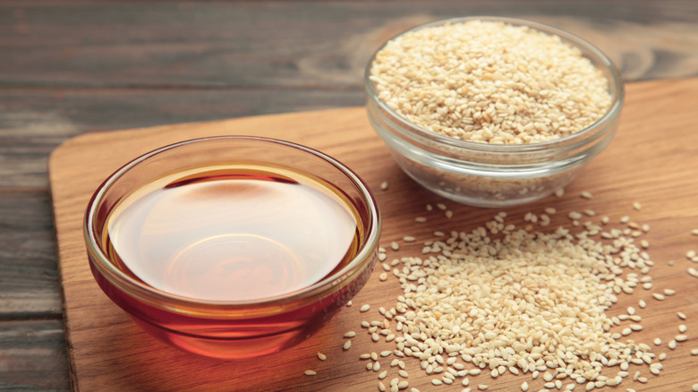 sesame oil in a glass bowl on a cutting board