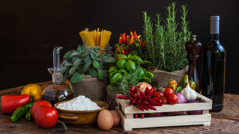 Various Italian ingredients, including herbs, oil, and pasta.