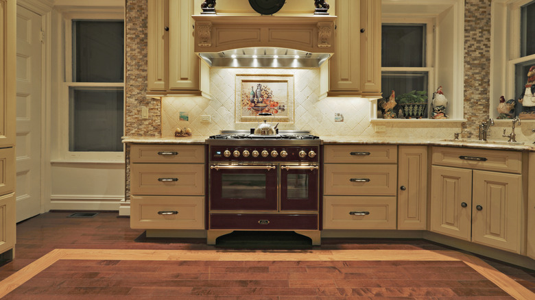 a high-end looking kitchen with a wooden hood cover over stove