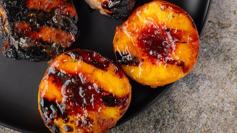 Grilled peach halves on a plate