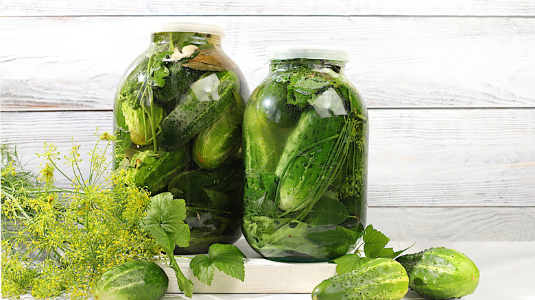 bright green pickles in glass jars
