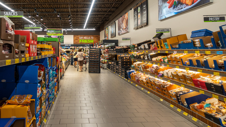 People shopping in the Aldi bread aisle
