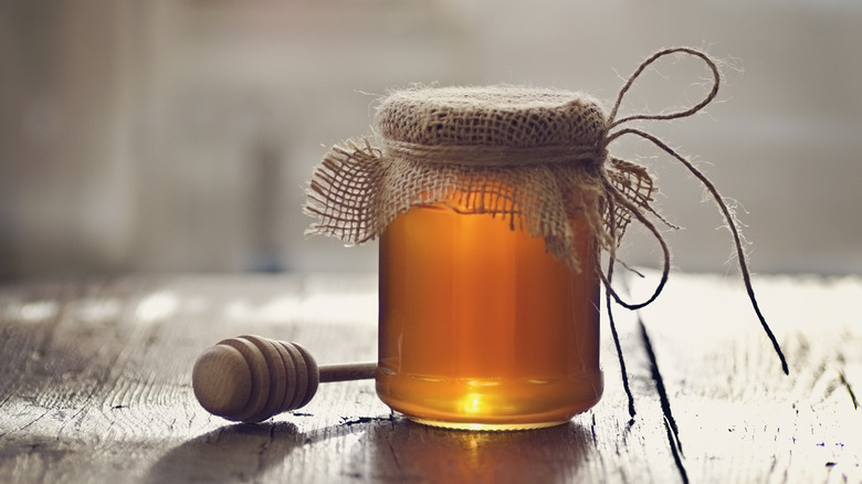 Golden honey in glass jar