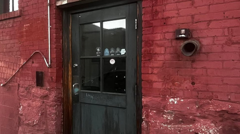 The door to the stairs of the Hogwash Whiskey Den