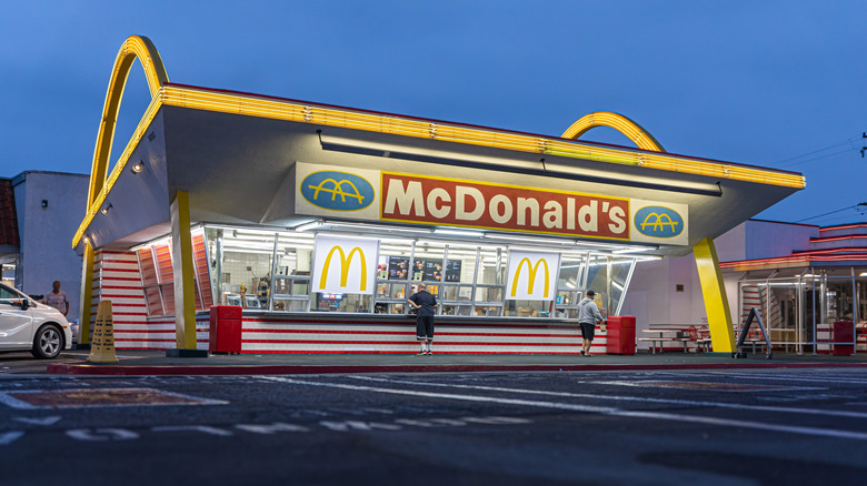 The historic McDonald's in Downey, California, lit up at night.