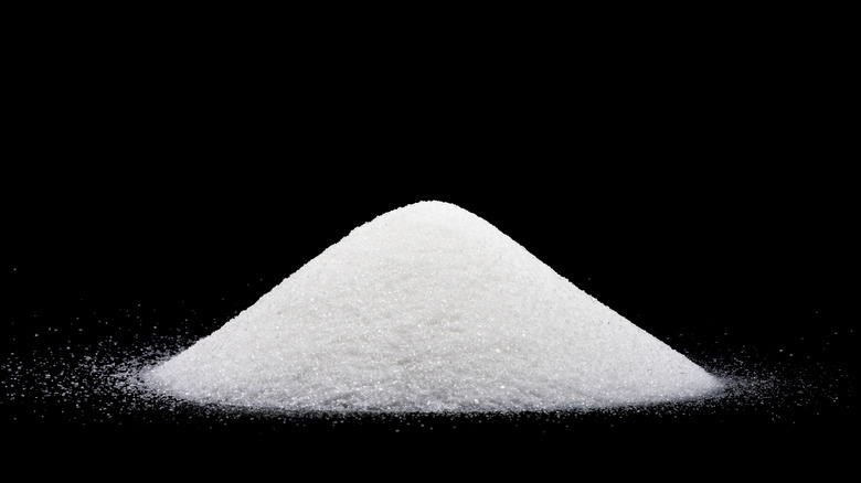 pile of sugar black background