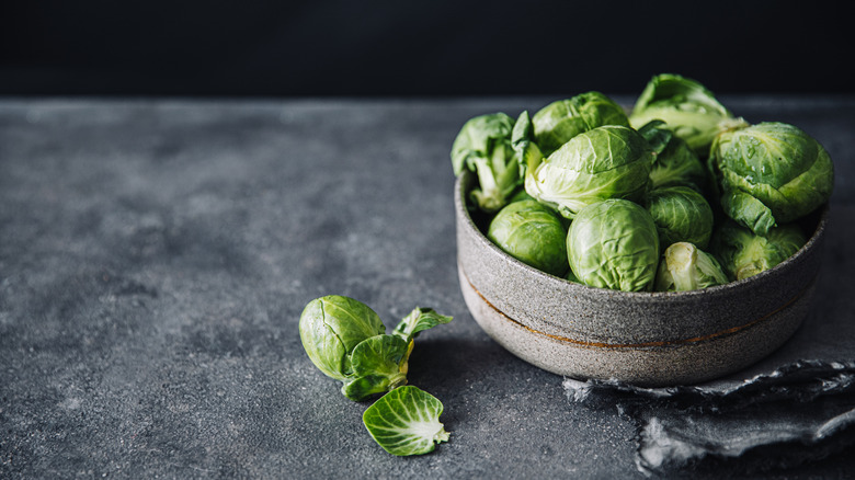 Loose Brussels sprouts in a bowl placed on a black table
