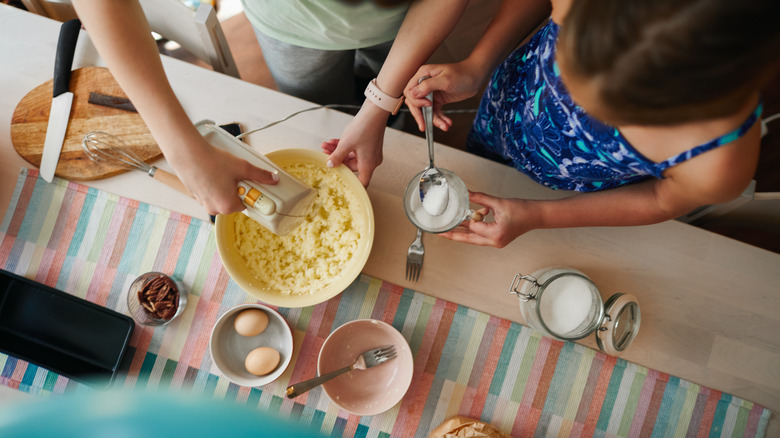 Two people making banana bread
