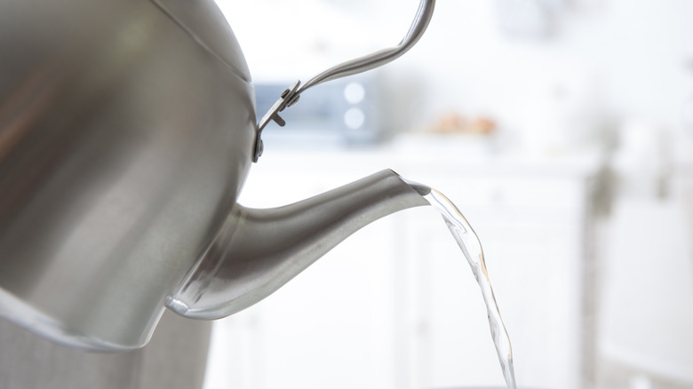 Tea kettle pouring hot water