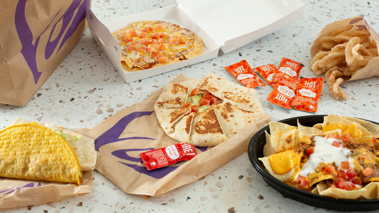 various Taco Bell items and packaging spread out on a counter