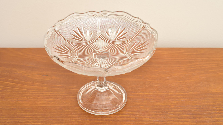 a glass platter on a wooden board