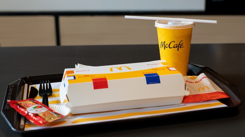 McDonald's breakfast burrito and hot drink on a train