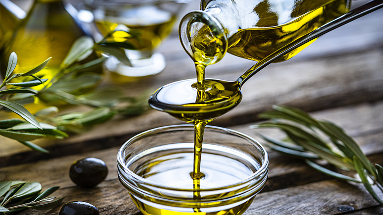 Olive oil pouring onto spoon