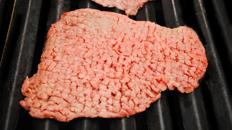 piece of cube steak on grill