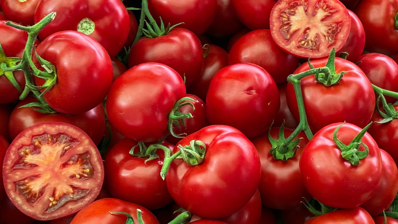 Juicy tomatoes glisten with dewdrops.