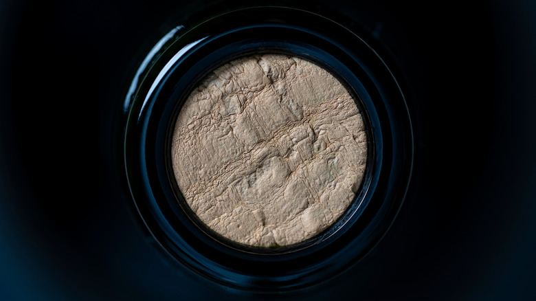 A wine cork inside a glass bottle.