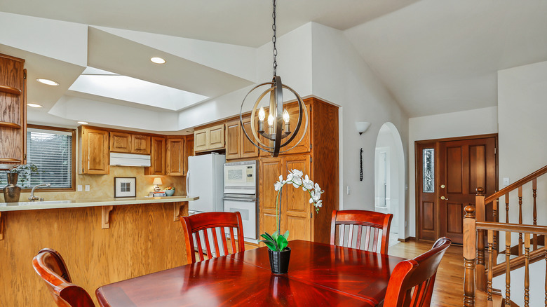 A kitchen's wooden cabinets have an orange tint.