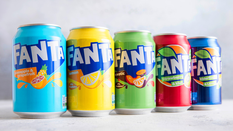 Various flavors of Fanta cans lined up in a row