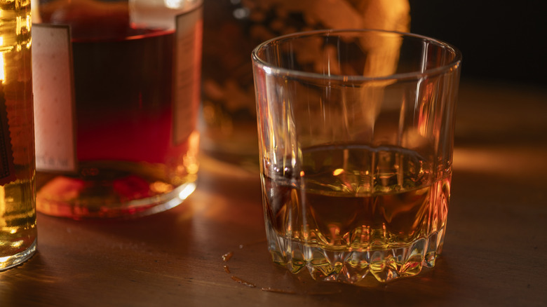 glasses of whiskey on wooden table