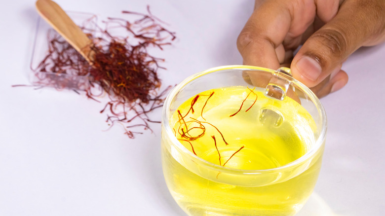 Saffron threads blooming in warm water