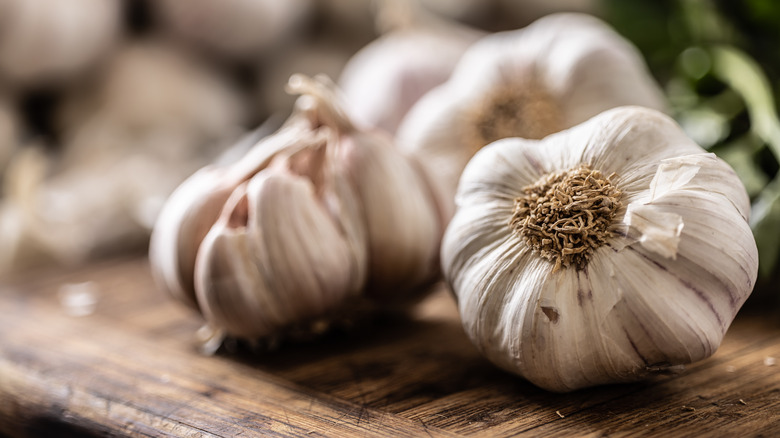 Whole heads of garlic on a cutting board