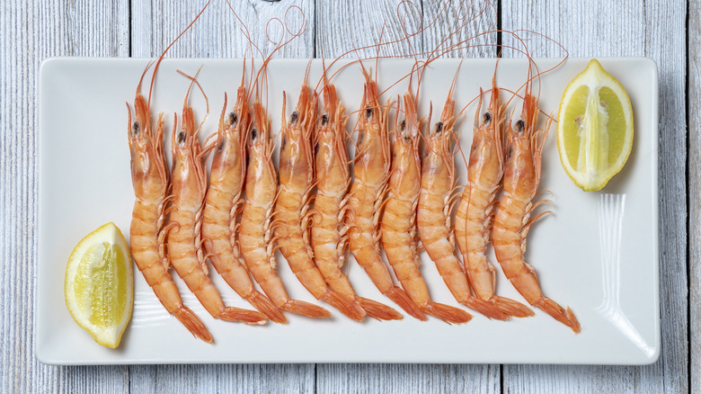 Platter of prawns on a wooden table. 