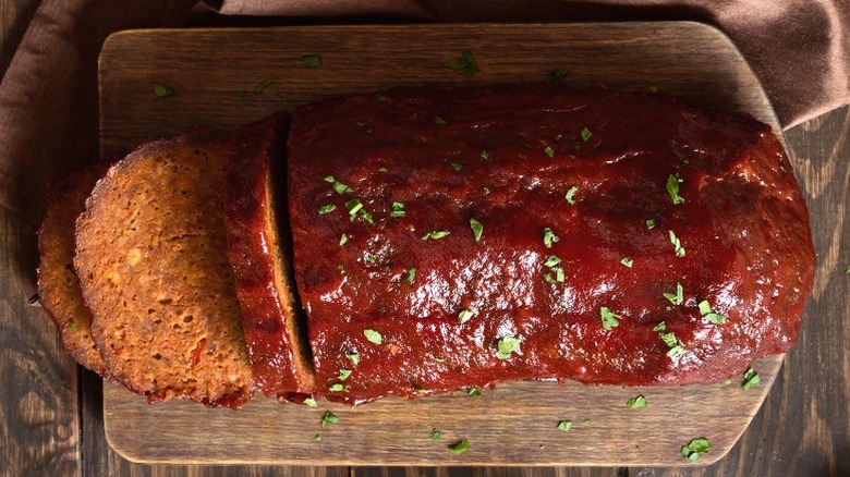 Sliced, glazed meatloaf on a cutting board