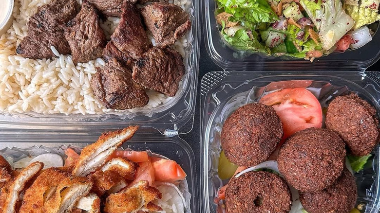 Falafel, chicken, steak and rice, and other Mediterranean dishes in plastic containers