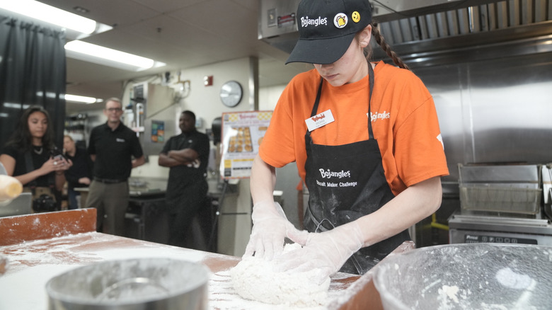A Bojangles master biscuit maker forms dough during the restaurant's master biscuit making competition