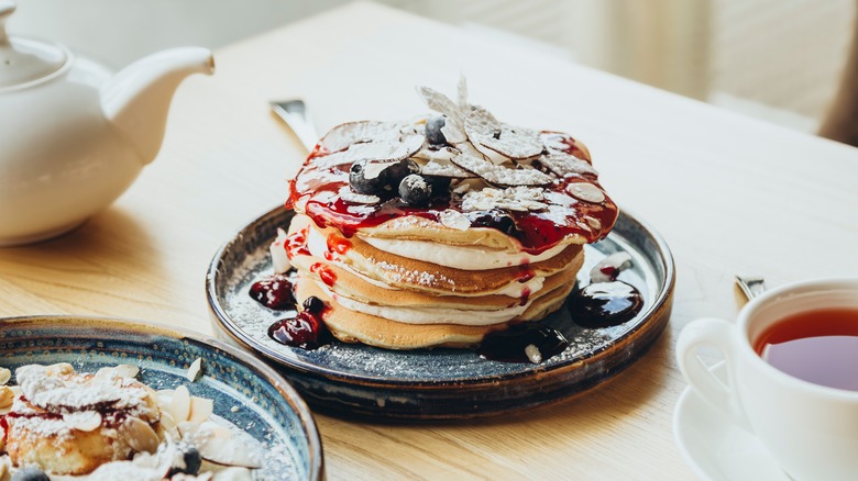 Pancakes with powdered sugar, blueberry syrup