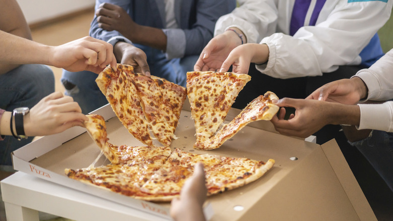 Picking up slices of pizza