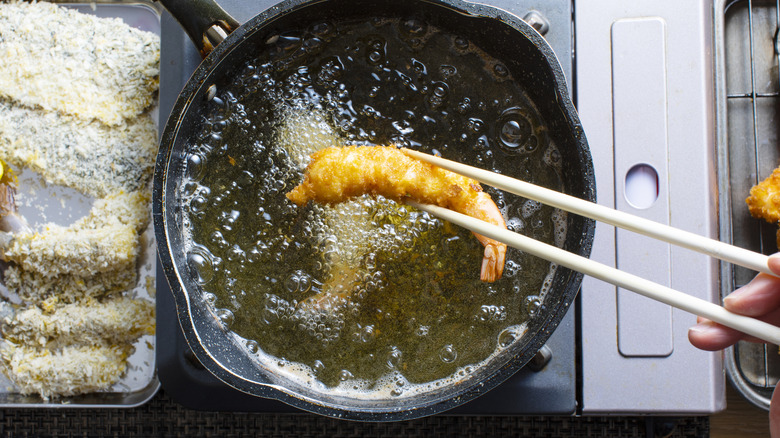 shrimp on parchment and then being fried