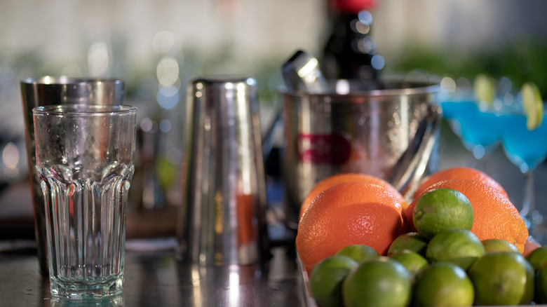 A home-bar setup with drink ware, fruits, and more
