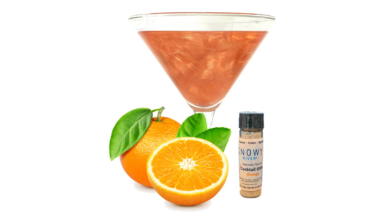 An orange glitter infused cocktail