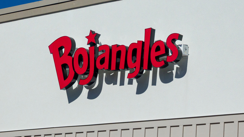 Red and Black Bojangles sign on white building exterior