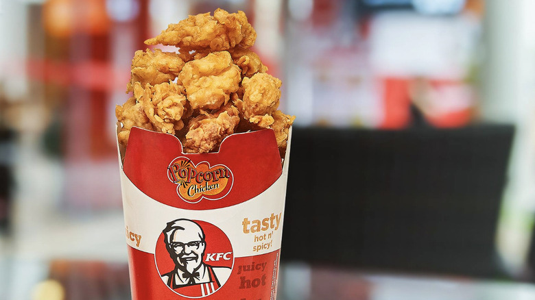 A KFC carton holding popcorn chicken.