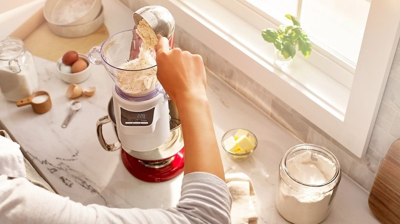 Pouring flour into kitchenaid sifter