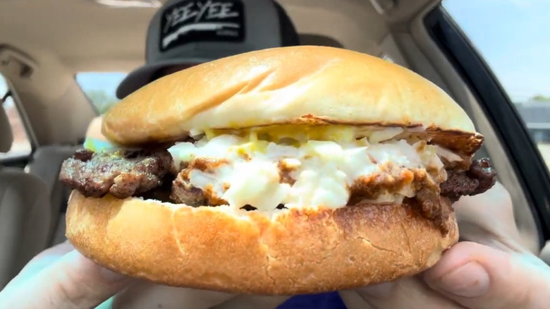 Hnad holding a Wendy's Carolina classic burger