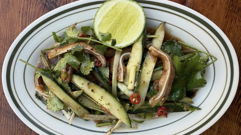 A plate of food from Bong garnished with half of a lime