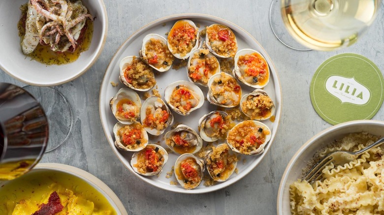 A few dishes from Lilia, with a plate of clams front and center