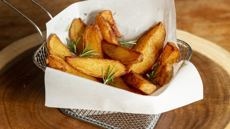 Golden-brown fries on parchment paper
