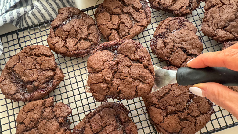 hand serving cookie on spatula