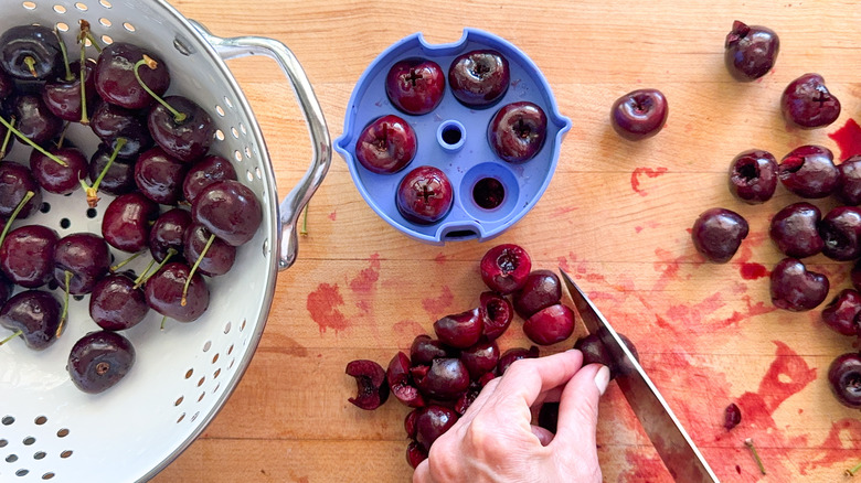 hand slicing cherries