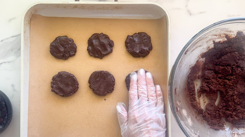 hand flattening ball of dough