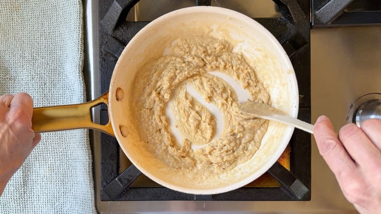 Stirring a roux in a small skillet on stovetop